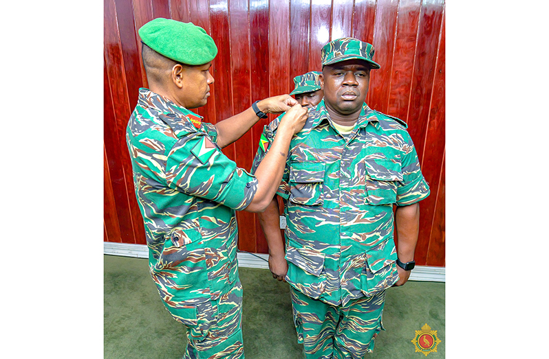 Chief of Staff, Brigadier Omar Khan, pins a new badge on Staff Sergeant Ashton Todd