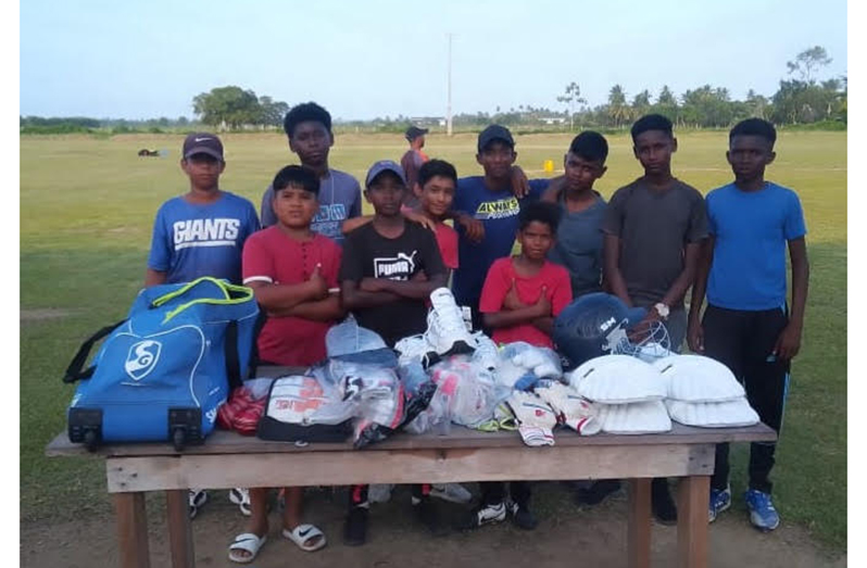 The young cricketers proudly display their cricket gear.