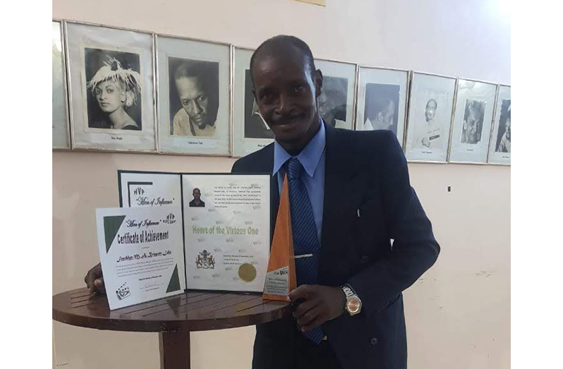 Franklyn Bisport-Luke poses with some of his sports credentials