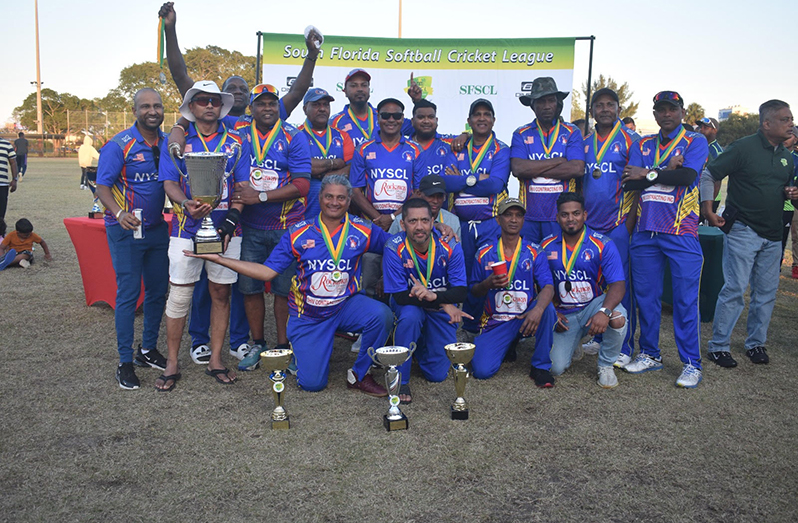 The victorious NYSCL Legends team pose with their winnings.