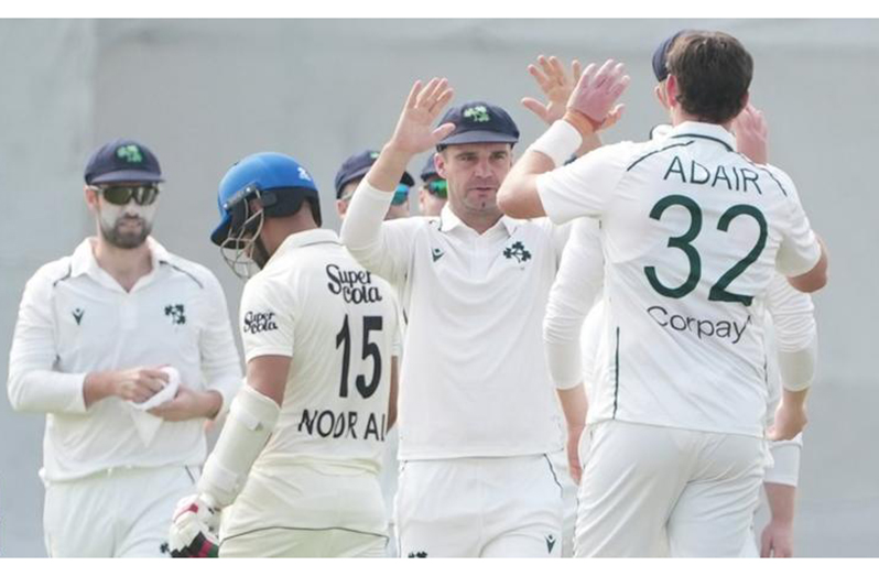 Ireland players congratulate Mark Adair after the seamer took one of his five wickets.