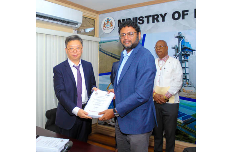 Permanent Secretary in the Public Works Ministry Vladim Persaud (right) and China Road and Bridge Corporation’s Senior Engineer Bo Zhang signed the contract on Thursday at the ministry’s Boardroom at Wight’s Lane, Kingston, Georgetown