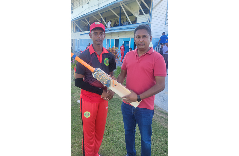 Gibran Yacoob (left), receives the bat from Vicky Bharosay