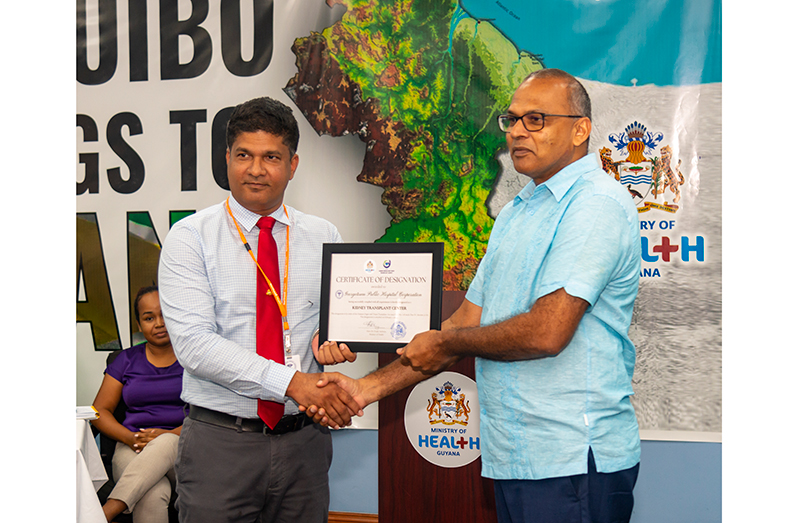 Minister of Health Dr Frank Anthony (right) presenting the certificate to Director of Medical and Professional Services- GPHC, Dr Navindranauth Rambaran on Wednesday (Japheth Savory photos)