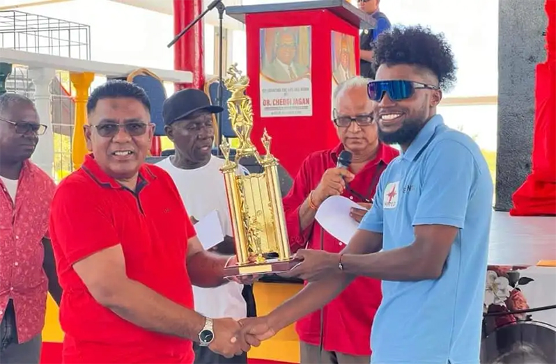 Briton John (right) receives his prize from PPP Executive Secretary Zulfikar Mustapha