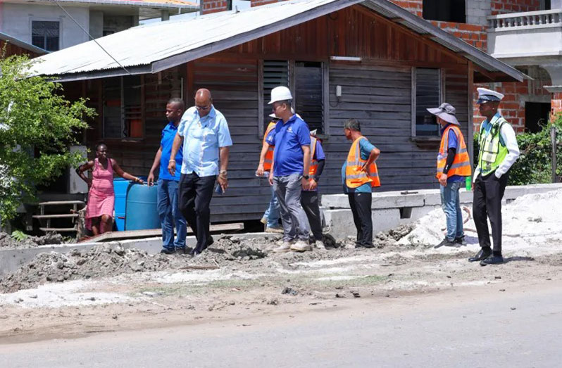 Minister of Public Works, Juan Edghill, contractor, engineer and others inspecting ongoing works on the road project