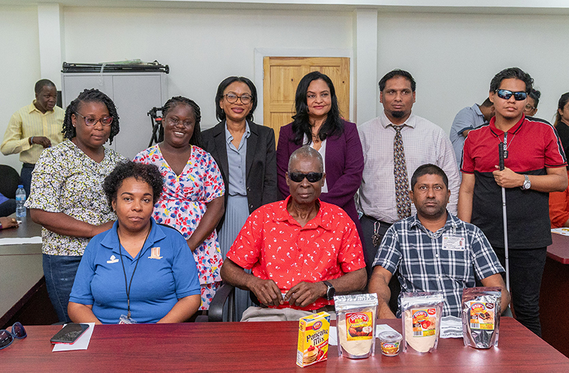 Minister of Tourism, Industry and Commerce, Oneidge Walrond; Minister of Human Services and Social Security, Dr Vindhya Persaud, and CEO of the Small Business Bureau, Shazim Ibrahim, with six of the eight persons who received loans from SBB