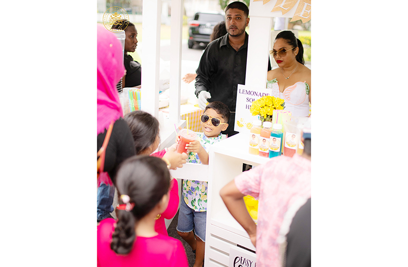 First Son, Zayd Ali, serving lemonade yesterday at his fundraiser