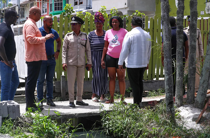Minister of Public Works, Bishop Juan Edghill, and Commissioner of Police (ag) Clifton Hicken engaging residents