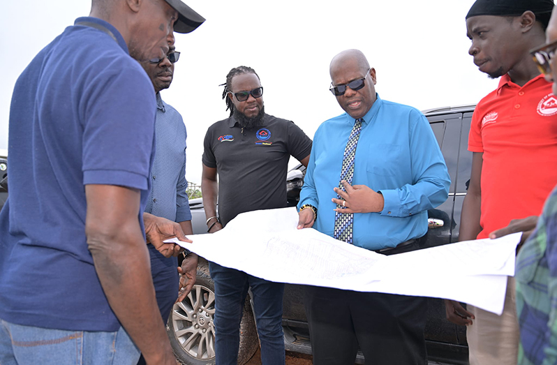 CEO of the CH&PA, Sherwyn Greaves, with contractors dealing with issues regarding halted infrastructural works due to a cluster of squatters