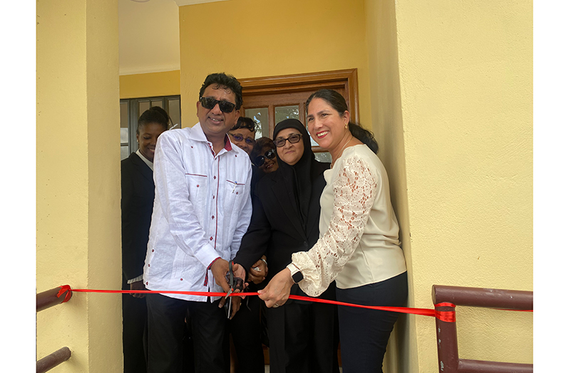 Anil Nandlall, the Attorney General and Minister of Legal Affairs, stands alongside Shalimar Ali Hack, the Director of Public Prosecutions, and Lorena Solorzano Salazar, the Country Representative to Guyana for the Inter-American Development Bank (IDB), as they join others in cutting the ribbon.