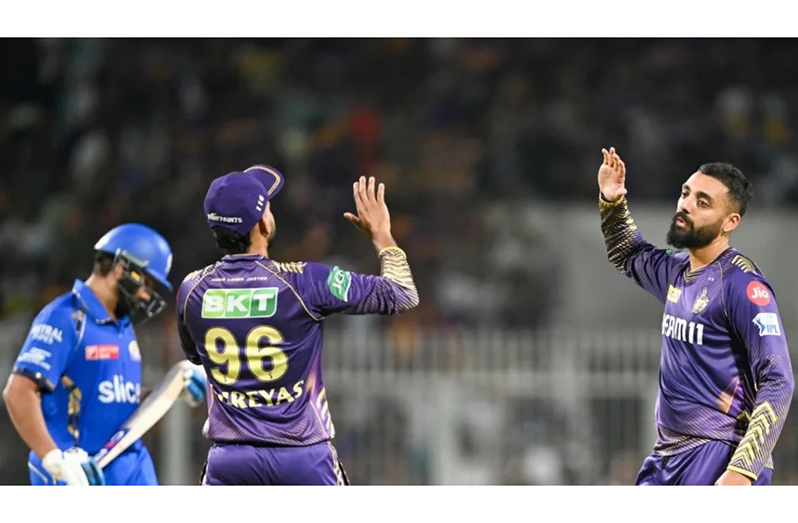 Varun Chakravarthy celebrates after getting Rohit Sharma out • (AFP/Getty Images)