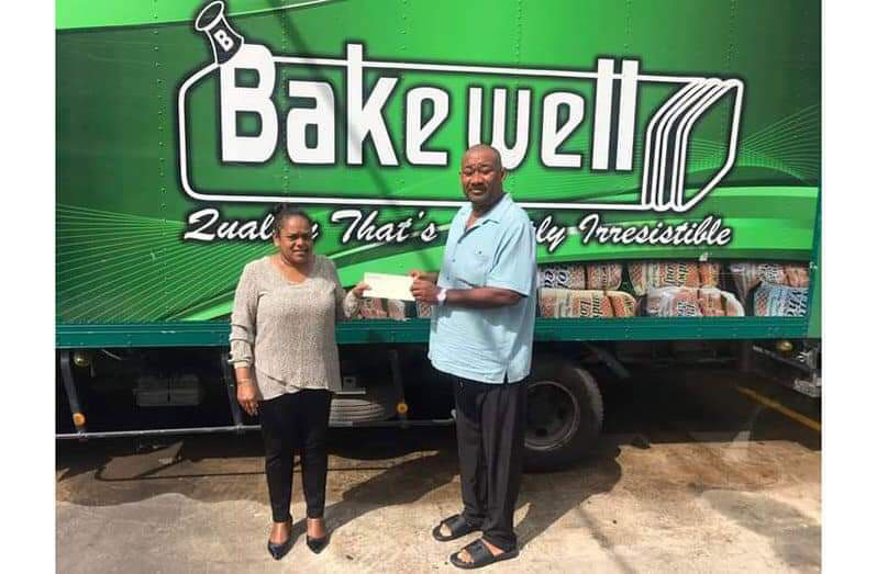 Bakewell Natasha Bhikhari hands overs sponsorship to RHTYSC secretary Hilbert Foster