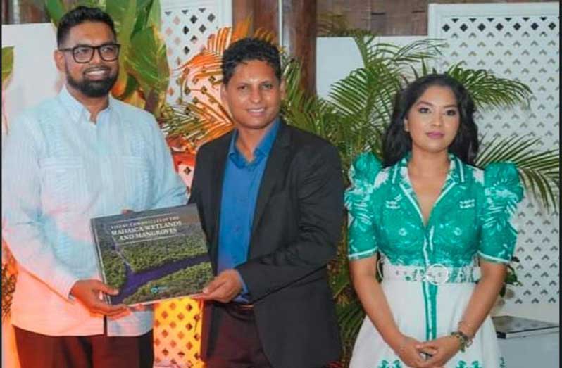 President Dr. Mohamed Irfaan Ali, the founder and director of the Environmental Management Consultants (EMC) Foundation, Shyam Nokta, and his wife Melisa Nokta at the “The Visual Chronicles of the Mahaica Wetlands and Mangroves” book launch on World Environment Day, 2024.