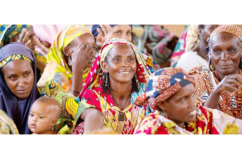 Women attend a community meeting in Cameroon (UN Women/Ryan Browm photo)