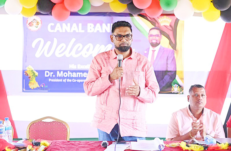 President Dr. Irfaan Ali addresses residents of Canal Bank in Region One. Also pictured is Housing Minister, Collin Croal