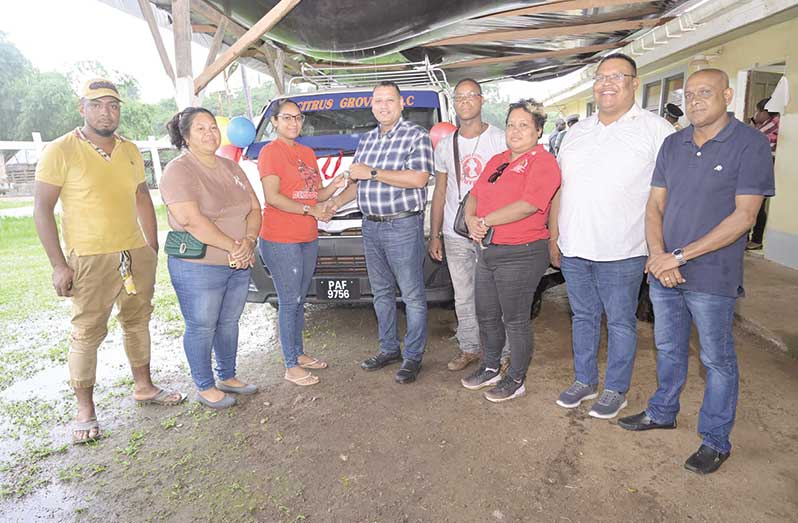 The Minister of Housing and Water, Collin Croal, handing over the keys for a new minibus to a representative of Citrus Grove. Also pictured are Regional Chairman Ashley Brentnol (second from right), and other representatives of the Region One community