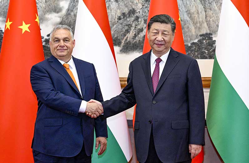 President Xi Jinping shakes hands with Hungarian Prime Minister Viktor Orban on Monday during their meeting at the Diaoyutai State Guesthouse in Beijing. The two leaders exchanged views on the Ukraine crisis and China-European Union relations, among other things (FENG YONGBIN/CHINA DAILY)