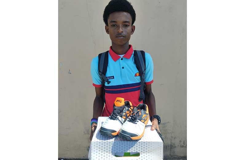 Troy David proudly displays his cricket shoes