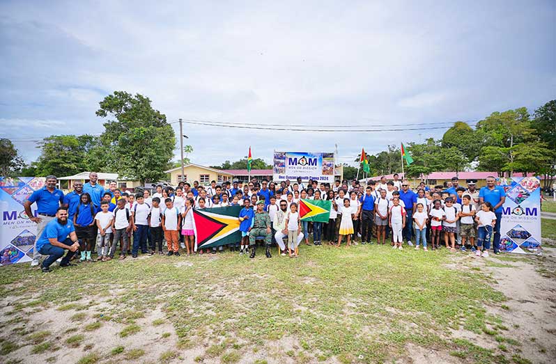 Seated: President Dr. Irfaan Ali with Chief of Defence Staff is Brigadier Omar Khan flanked by Men on Mission officials with children that will engage in a series of exciting and enjoyable activities with the purpose of fostering discipline, cultivating friendships, and encouraging self-reliance (Office of the President photo)  