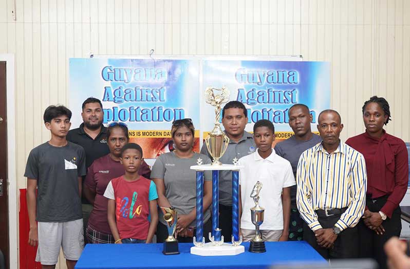 Organisers and participating representatives pose for a photo with the trophy