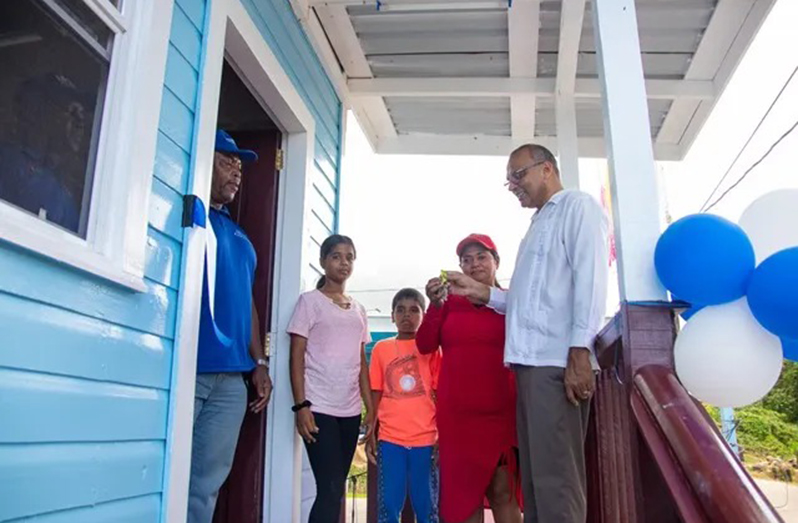 Minister of Health, Dr Frank Anthony, hands over the house keys to Shamdai Pumu