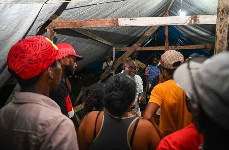 Minister within the Office of the Prime Minister with responsibility for Public Affairs, Kwame McCoy meeting with the displaced Sarah Johanna squatters