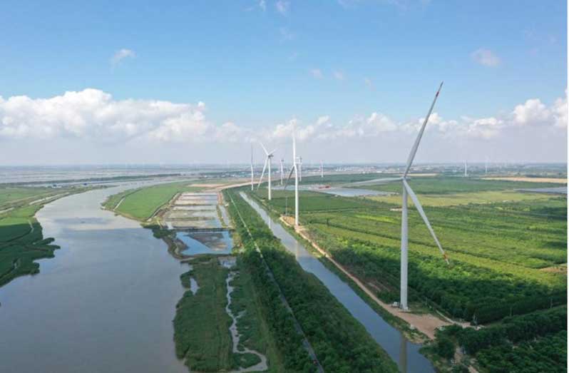 An aerial drone photo taken on June 6, 2024, shows the wind-power equipment at a low (zero) carbon-dioxide emission industrial park in Sheyang, Yancheng, East China's Jiangsu province [Photo/Xinhua]