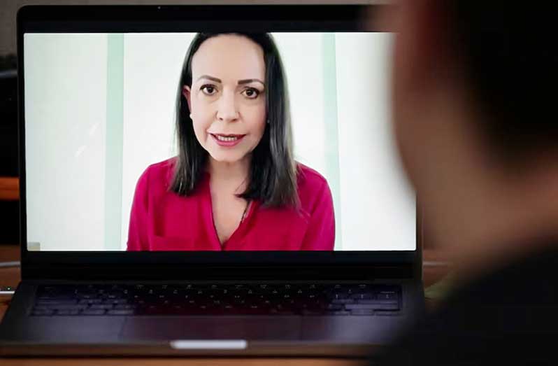 Venezuela's opposition leader Maria Corina Machado is seen on a laptop screen during a virtual press conference with foreign media, in Caracas, Venezuela, September 5, 2024 (REUTERS/Gaby Oraa)