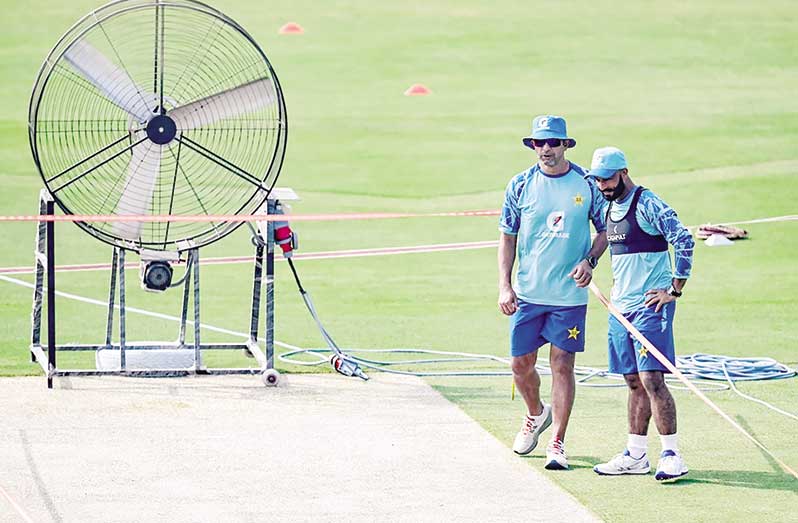 Azhar Mahmood and Sajid Khan take stock as a giant fan does its work on the Rawalpindi pitch  • (AFP/Getty Images)