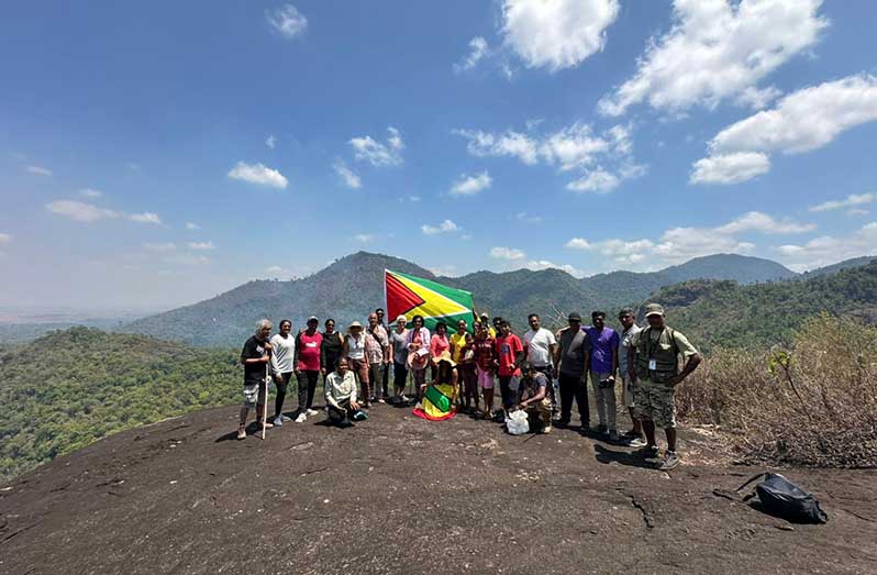 Operators of Touring Guyana and a group of patrons on Kanuku Mountains in Region Nine