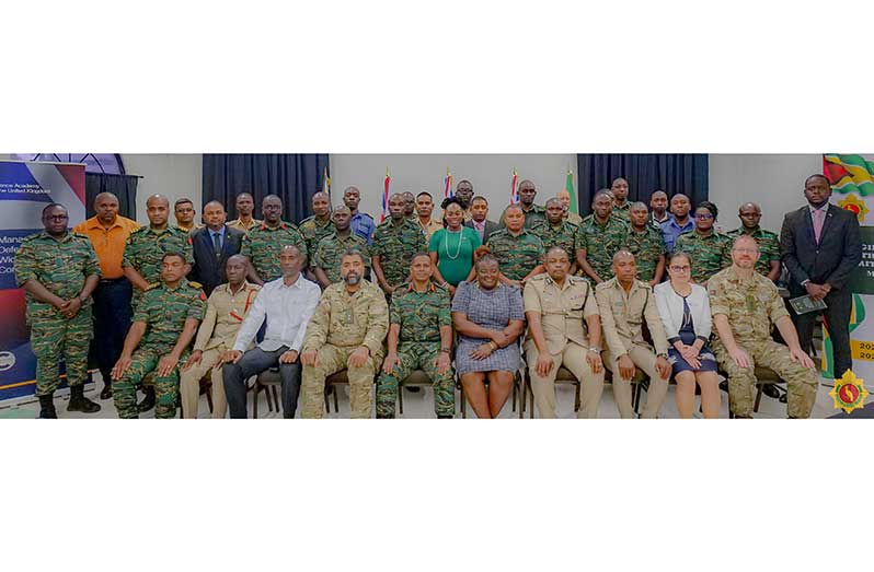 Chief of Defence Staff, Brigadier Omar Khan, MSS (seated at centre) flanked by Deputy High Commissioner of the United Kingdom to Guyana, Judy Omasan Kpogho and senior officers and officials, at the commencement of the Managing Defence in the Wider Security Context Course 2025