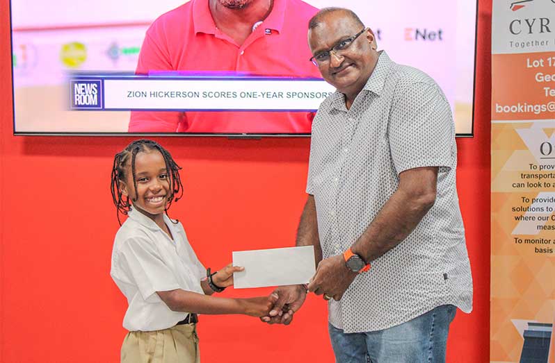 Sunil Persaud of Cyril's Transportation Service makes a presentation to Zion Hickerson 