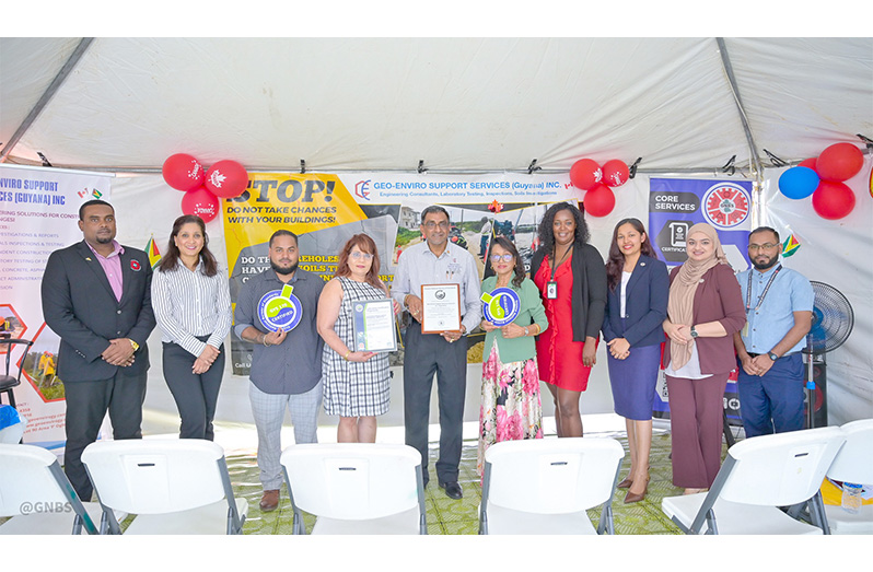 Taijpaul Dayaram, Business Owner (Centre) with wife to his right and sister to his left including lab employees and staff of the GNBS