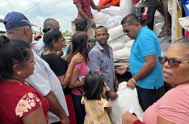 Minister of Agriculture, Zulfikar Mustapha, hands over hampers to residents in Black Bush Polder on Sunday—ensuring every household received support amid ongoing flood relief efforts