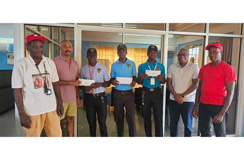 In this photo, Queensway's Chief Operations Officer Lancelot Khan, (second from left) hands over a cheque ro Joel Williamson. Others in the photo are,  from left to right: coach Gregory 'Chassis' Cort, Jamal Eastman, Terron Wintz, Steve Ninvalle and Coach Jeff Roberts