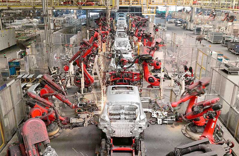 Robotic arms work in a smart workshop of a factory of Chinese new energy vehicle (NEV) manufacturer Leapmotor in Jinhua, east China's Zhejiang province, May 13, 2025 (Photo by Shi Bufa/People's Daily Online)