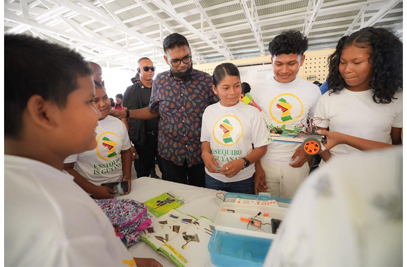 President, Dr Irfaan Ali yesterday interacted with children who are participating in the Ministry of Culture, Youth and Sport’s robotics camp at Anna Regina Secondary School. The children, have so far, completed over three weeks of robotics training (Office of the President photos)