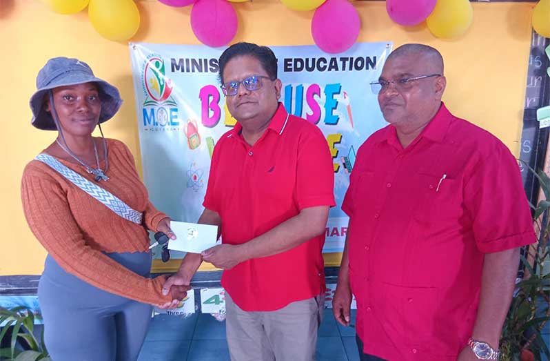 Senior Minister in the Office of the President with Responsibility for Finance and the Public Service Dr. Ashni Singh on Wednesday participated in the ‘Because We Care’ cash grant distribution in Region Six