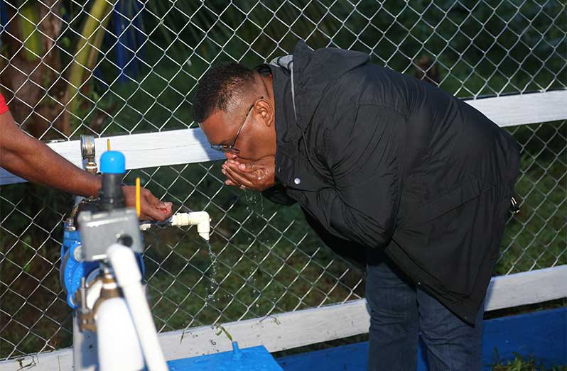 Regional Chairman, Brentnol Ashley, takes a refreshing sip from the Hobodeia water supply system