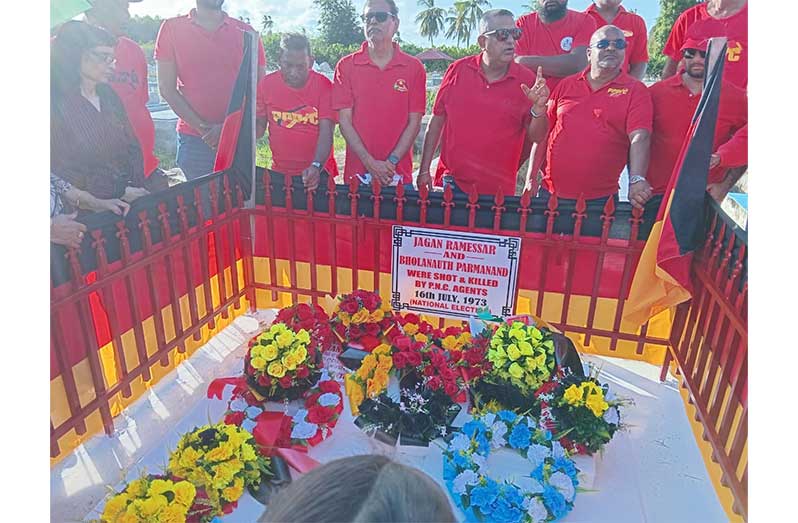 Dr. Vishwa Mahadeo, Director General of the Ministry of Health
(fifth from left) flanked by PPP activists who paid tribute at the
simple wreath-laying ceremony for the Ballot Box Martyrs