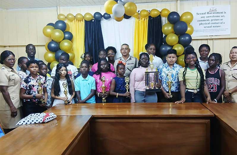 Commander Khali Pareshram (centre) flanked by Police Youth and Scout Group members, along with children of police officers, who recently wrote the NGSA and his Administrative Team