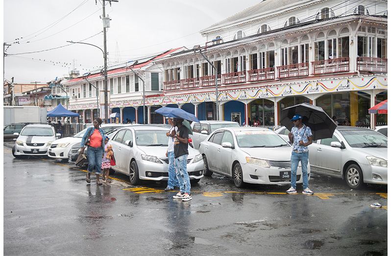 Taxi drivers sourcing passengers outside of Demico House, Stabroek (Delano Williams photos)