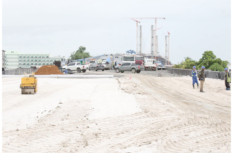 Works on the New Demerara River Bridge is moving apace with the full 2.9km concrete structure to be completely connected by August 25.  During a recent site visit, Minister of Public Works Hon. Bishop Juan Edghill was briefed on the progress of the works by the contractor and consultant. Minister Edghill also witnessed the paving of asphalt and other ongoing installation works. All efforts are being made to ensure the completion of the bridge for its August 31 timeframe.