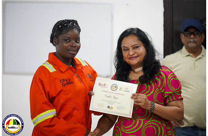 Orpha Hope receives her certificate from Minister of Human Services and Social Security, Dr Vindhya Persaud (Ministry of Human Services and Social Security photos)