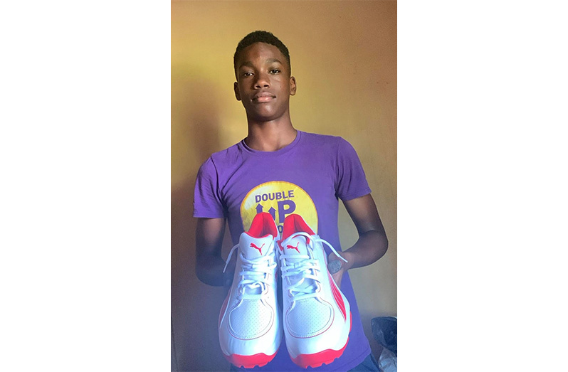 Kelvin Henry poses with his cricket shoes