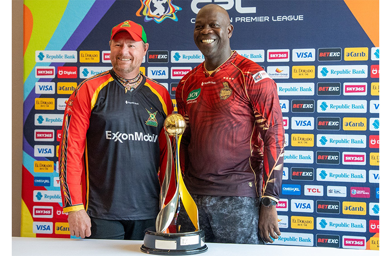 Guyana Amazon Warriors Head Coach Lance Klusener (left) and Trinbago Knight Riders Assistant Coach Ottis Gibson with the prized trophy on Saturday (PHOTO: News Room)