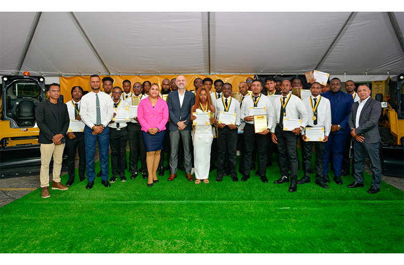 The 23 trainee technicians along with (from left) Anil James, Industrial Liaison Officer, Faculty of Engineering and Technology, University of Guyana; Dr. Ritesh Tularam, Deputy CEO (Technical), Ministry of Education; Weneta Pooran, Training Coordinator, MACORP; German Consuegra, President and General Manager of MACORP; Neilson Mc Kenzie MACORP’s Human Resource Manager and Miguel Oviedo, Training Manager, MACORP
