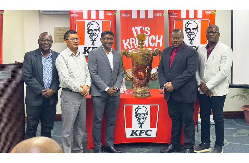 From left: Troy Peters (Petra Organisation), Deputy Chief Executive Officer Marti DeSouza, Paul Subryan (CEO of KFC Guyana), Troy Mendonca (Petra Organisation) and Franklin Wilson (Assistant Director of Sport) and the championship trophy at the launch on Wednesday evening (Japhet Savory Photo)