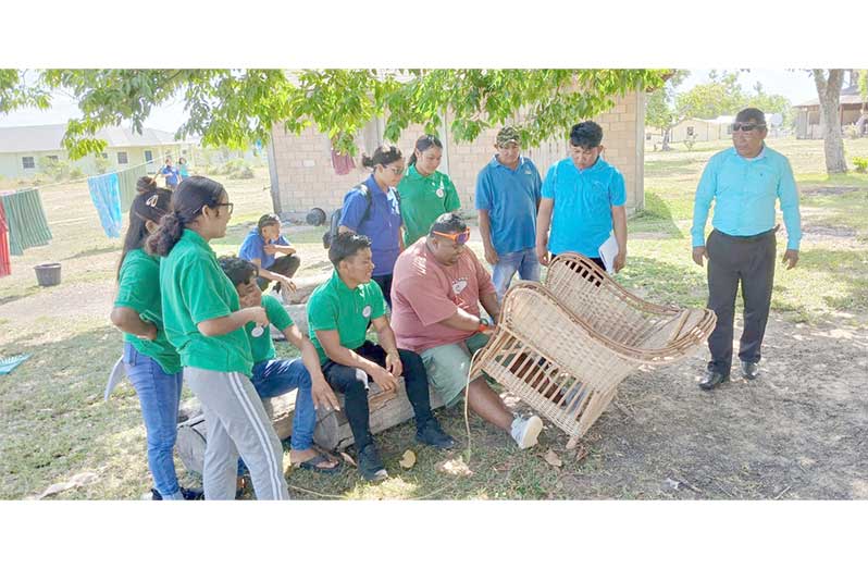 Students of Bina Hill Institute along with their tutor observing the presenter making the Kufa chair